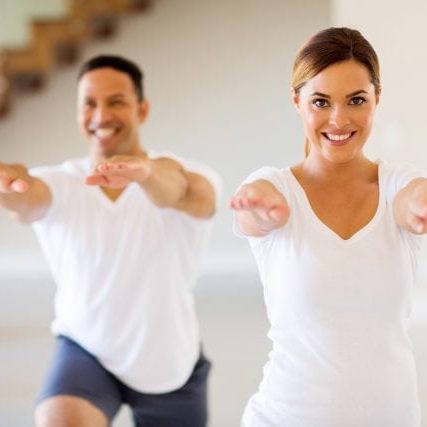 happy young woman exercising with boyfriend